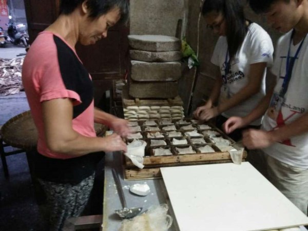 调研人员与豆坊工作人员一起制作豆饼