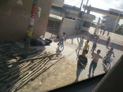 学生边挥手边追着汽车跑