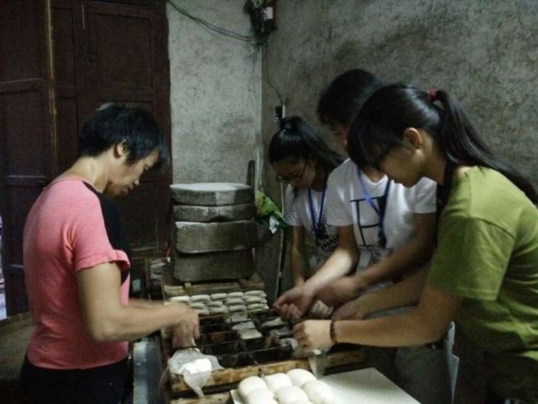 调研人员体验豆饼制作